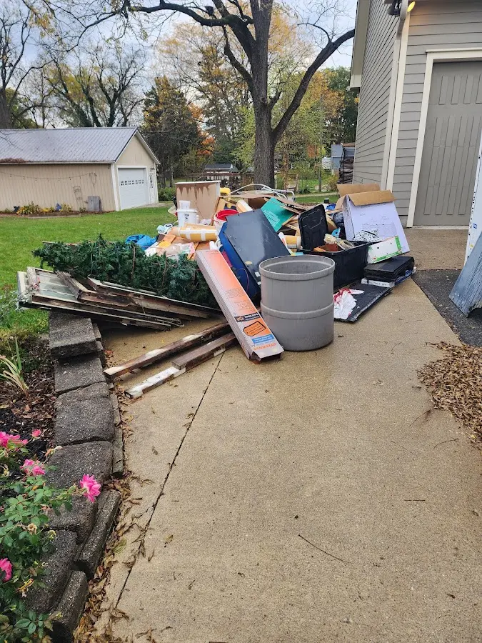 Dumpster being loaded with debris for Residential Dumpster Rental in Thomaston